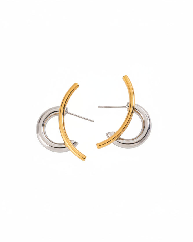 Pair of gold and silver hoop earrings on a white background