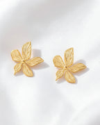 Gold butterfly-shaped earrings on a white background