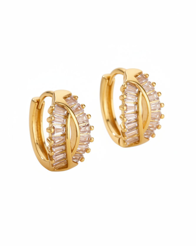 Gold hoop earrings with a white background