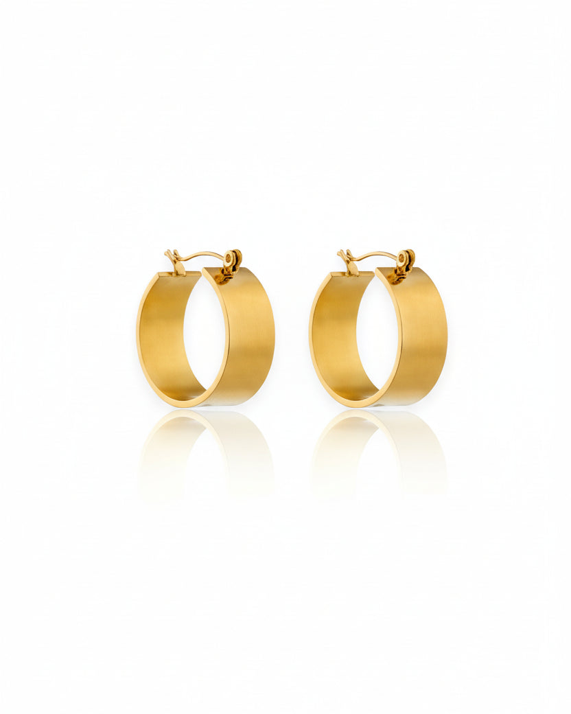 Gold hoop earrings on a white background