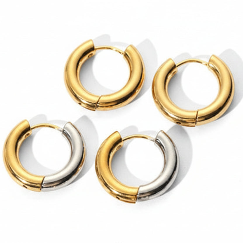 Set of gold and silver hoop earrings on a white background