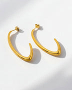 Gold hoop earrings on a white background
