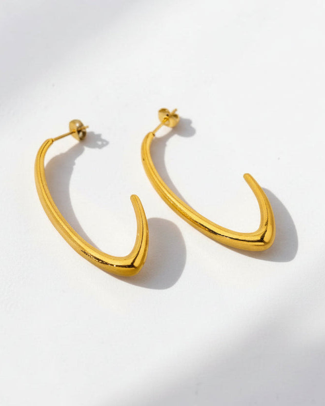 Gold hoop earrings on a white background