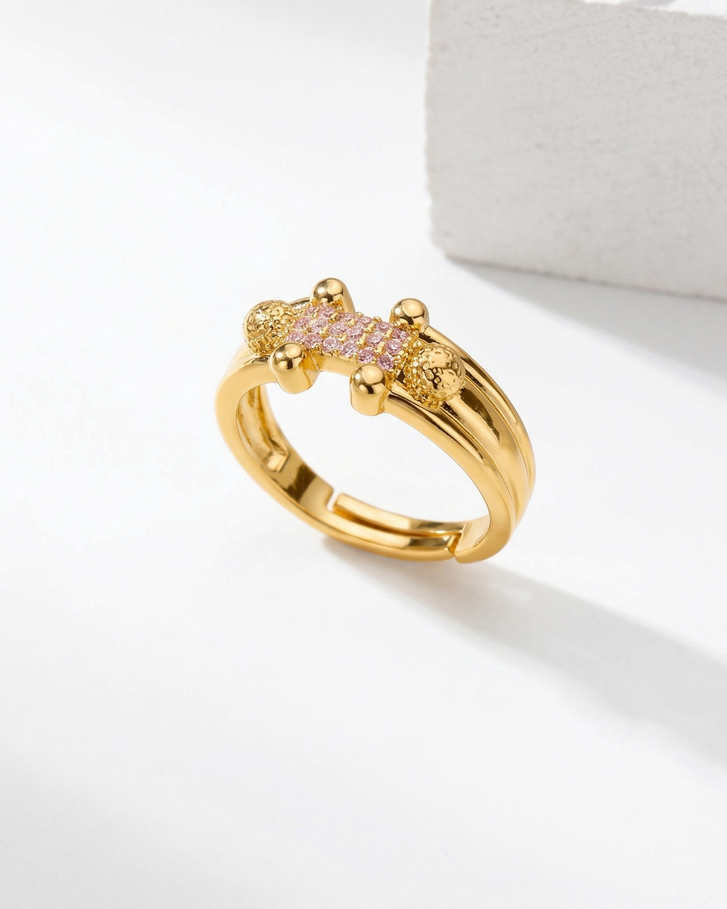 Gold ring with gemstones on a white background
