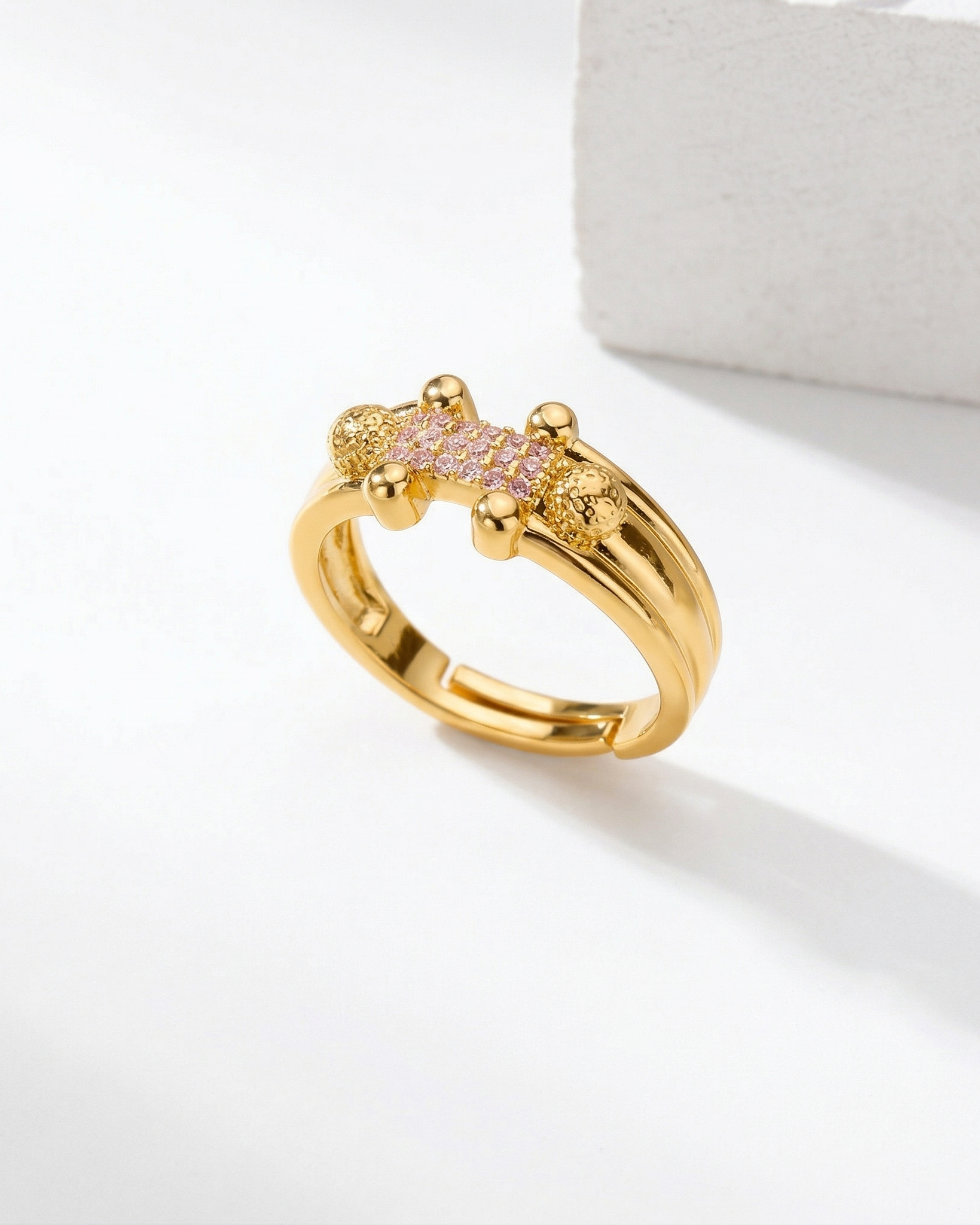 Gold ring with gemstones on a white background