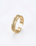 Gold open ring with textured design on a white background