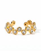 Gold hoop earrings with embedded crystals on a white background