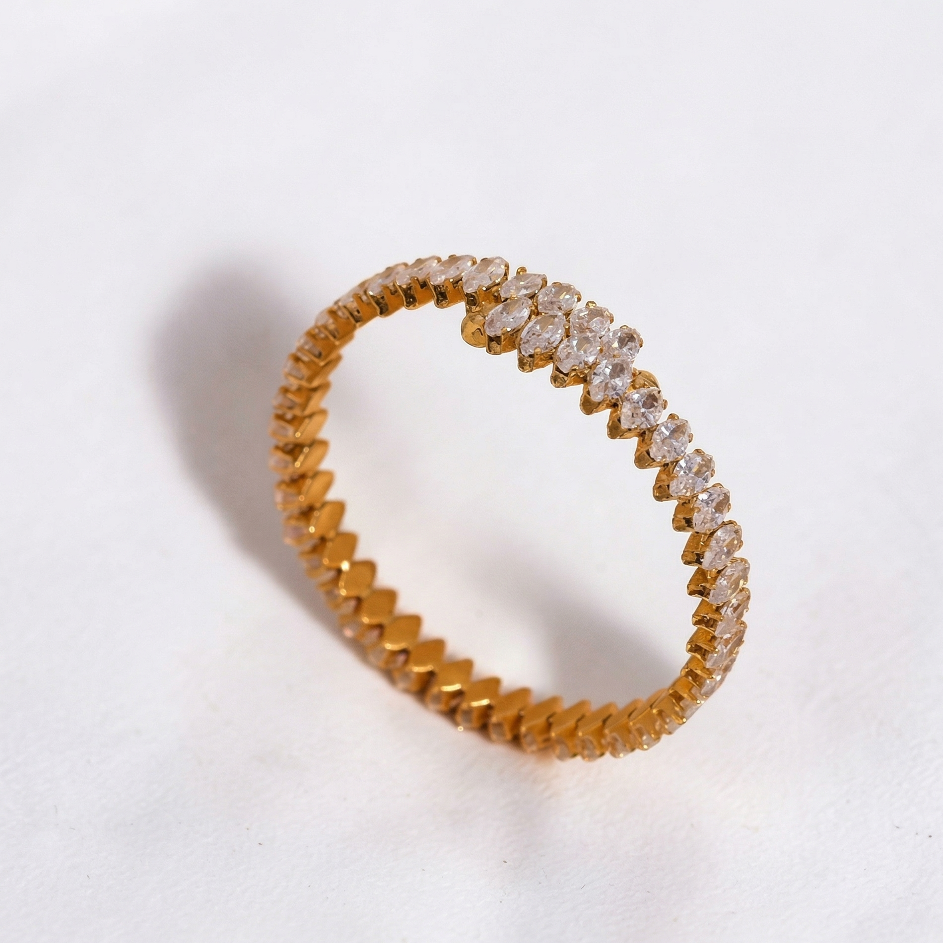 Gold ring with diamond accents on a white background
